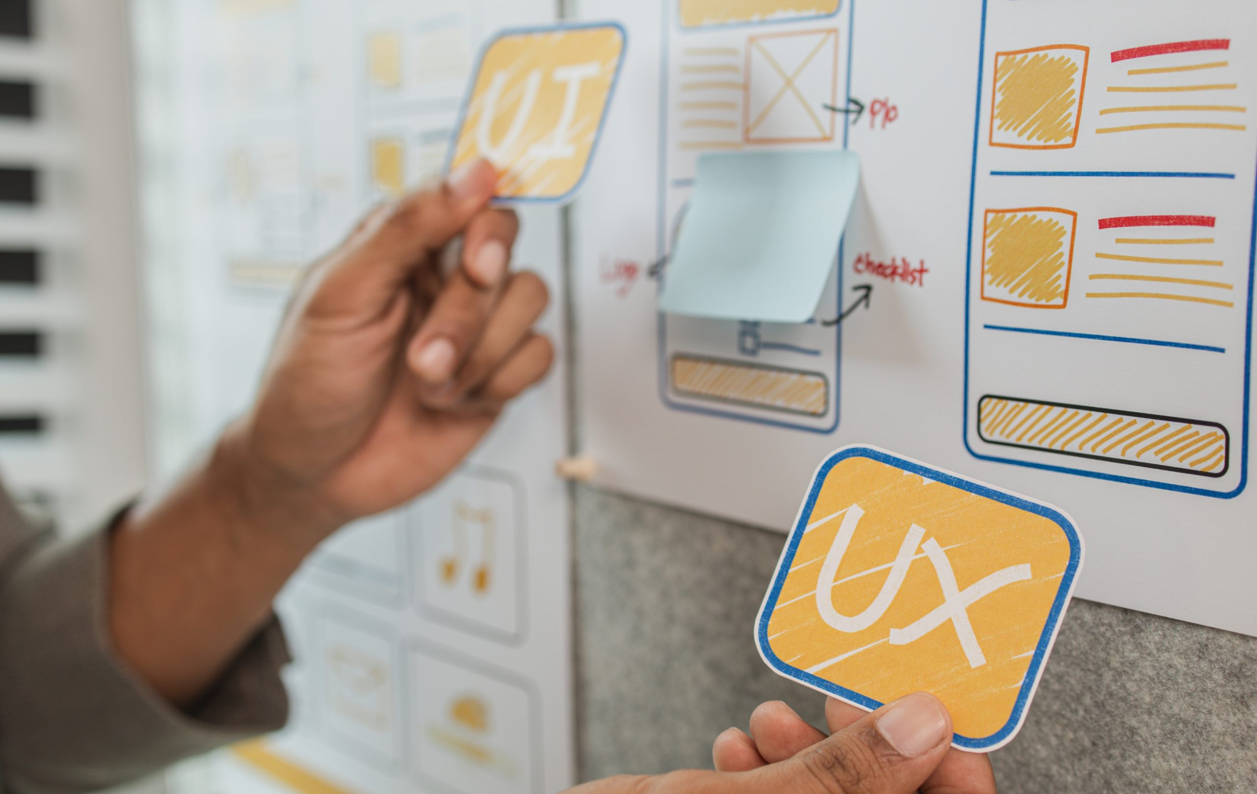UI UX designers team working on new website wireframe in office, ux developer and ui designer use augmented reality brainstorming about mobile app interface wireframe design on desk at modern office