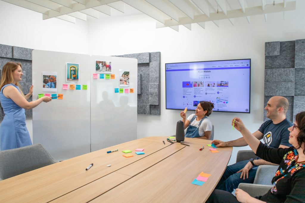 A group of people sitting around a table, discussing Visual story telling.